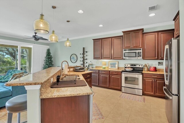 9312 Coachman Dr, Venice, FL 34293 - kitchen with visible vents, light tile patterned flooring, stainless steel appliances, a kitchen bar, and crown molding