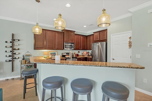 9312 Coachman Dr, Venice, FL 34293 - kitchen with light stone countertops, a breakfast bar, light tile patterned flooring, appliances with stainless steel finishes, and crown molding
