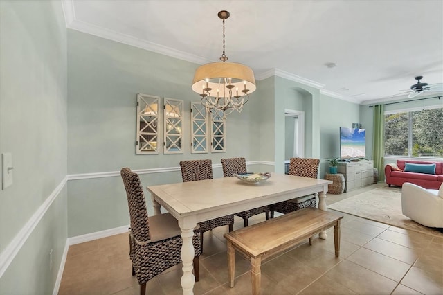9312 Coachman Dr, Venice, FL 34293 - dining space featuring tile patterned flooring, ceiling fan with notable chandelier, baseboards, and ornamental molding
