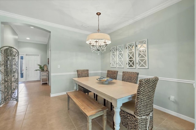 9312 Coachman Dr, Venice, FL 34293 - dining space with ornamental molding, arched walkways, light tile patterned flooring, baseboards, and a chandelier
