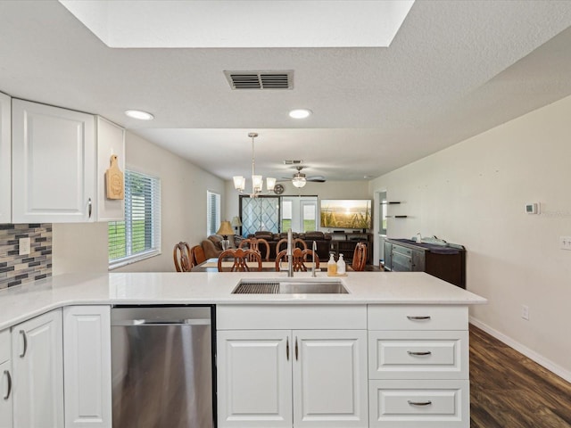 kitchen featuring a sink, backsplash, dishwasher, open floor plan, and visible vents