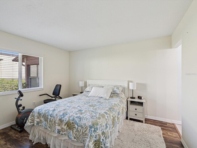 bedroom featuring baseboards and wood finished floors