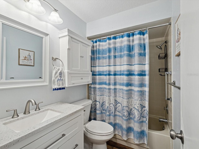 full bath featuring shower / bath combo with shower curtain, toilet, vanity, and a textured ceiling