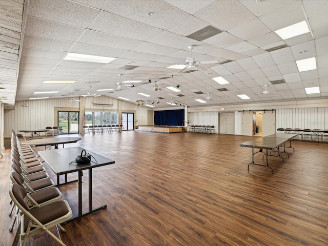 miscellaneous room with lofted ceiling, ceiling fan, wood finished floors, and a paneled ceiling