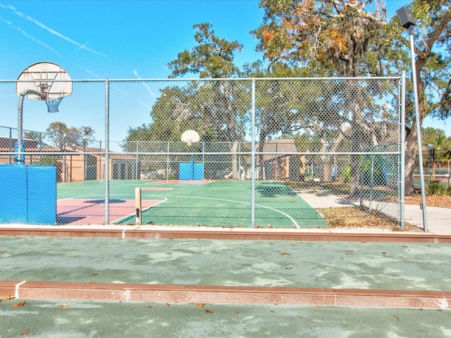 surrounding community featuring community basketball court and fence