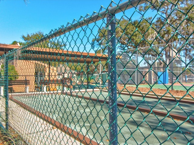 view of tennis court with fence
