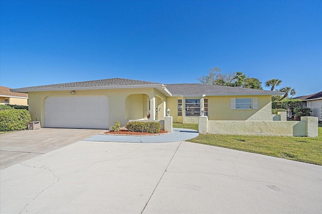 1003 N Gondola Dr, Venice, FL 34293 - single story home featuring concrete driveway, an attached garage, a front yard, and stucco siding