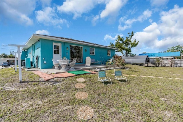 rear view of house featuring cooling unit, a lawn, a patio, and fence