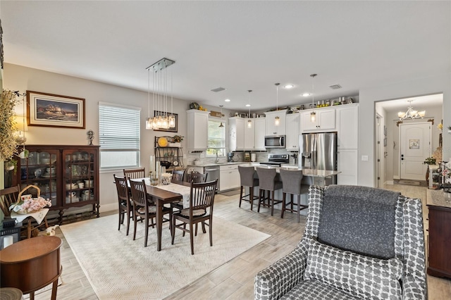 11655 Renaissance Blvd, Venice, FL 34293 - dining room with baseboards, light wood-style floors, recessed lighting, and an inviting chandelier