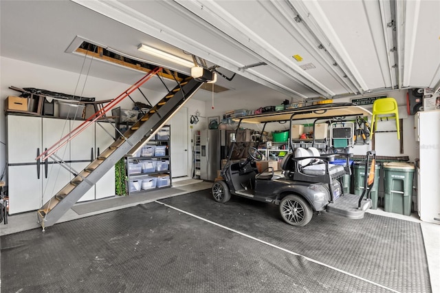 11655 Renaissance Blvd, Venice, FL 34293 - garage featuring a garage door opener and stainless steel refrigerator with ice dispenser