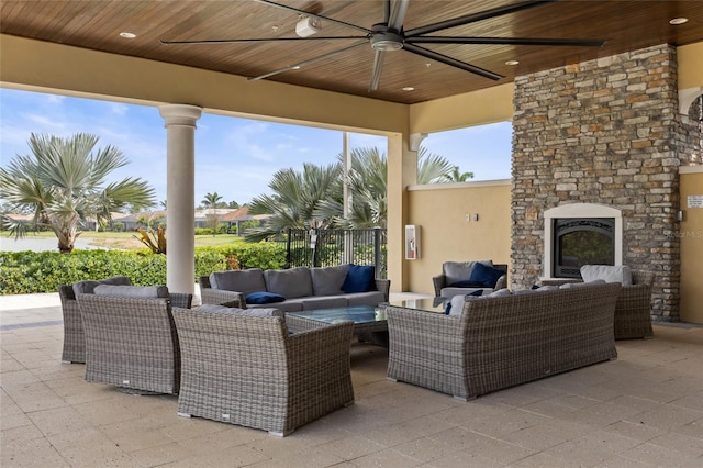 11655 Renaissance Blvd, Venice, FL 34293 - view of patio / terrace with a ceiling fan, fence, and an outdoor living space with a fireplace