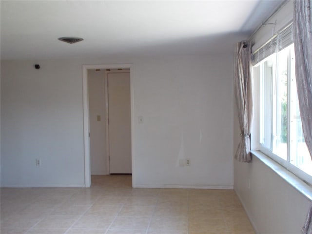 spare room featuring baseboards