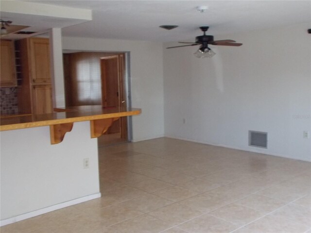 spare room featuring ceiling fan and visible vents