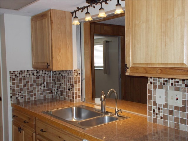 kitchen featuring a sink, light brown cabinetry, and decorative backsplash