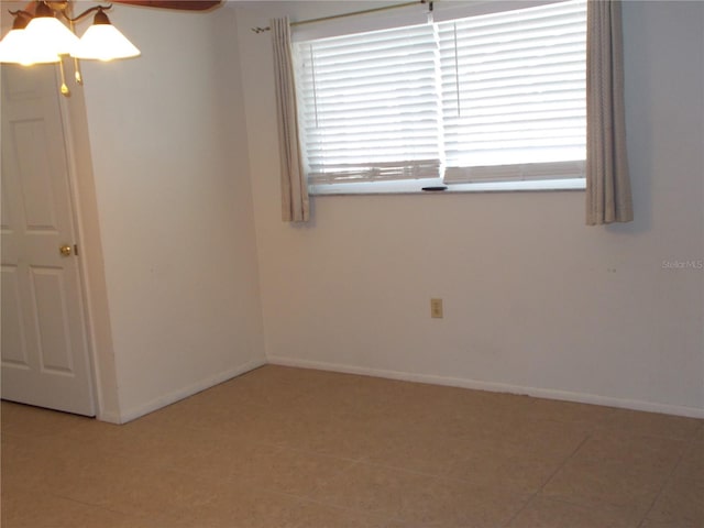 unfurnished room with tile patterned flooring, baseboards, and ceiling fan