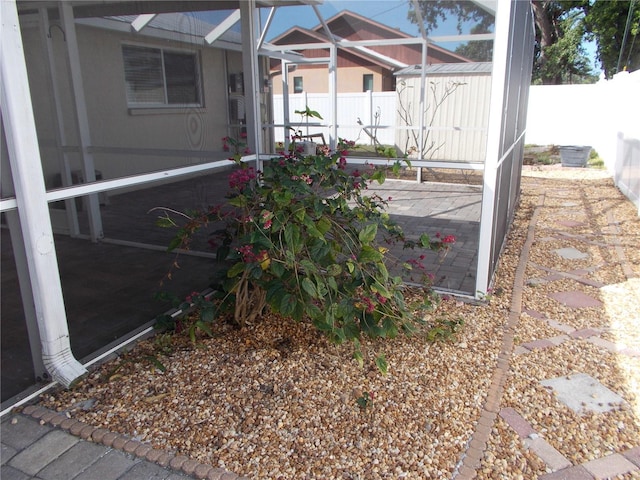 exterior space with an outdoor structure, fence, and a storage shed