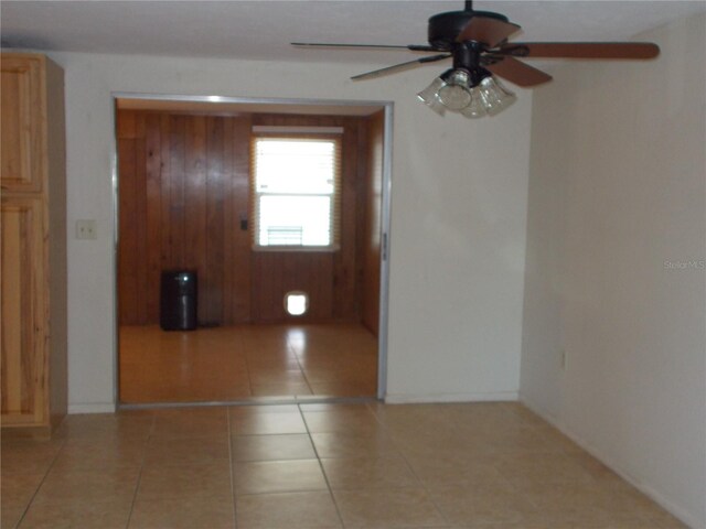 spare room with ceiling fan and light tile patterned floors