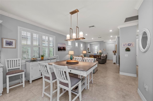 dining space with arched walkways, ornamental molding, visible vents, and a healthy amount of sunlight