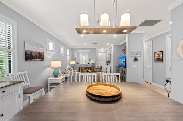 dining space with baseboards, ornamental molding, a healthy amount of sunlight, and recessed lighting