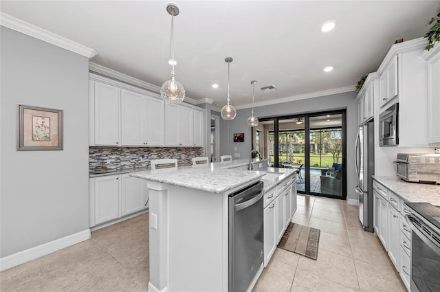 kitchen featuring a center island with sink, stainless steel appliances, crown molding, and tasteful backsplash