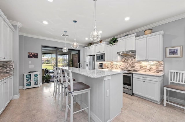 kitchen with white cabinets, ornamental molding, appliances with stainless steel finishes, and under cabinet range hood