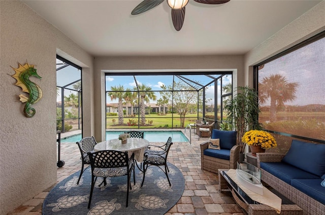 sunroom with an outdoor hangout area, ceiling fan, and a swimming pool