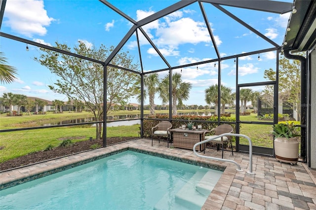 view of swimming pool featuring glass enclosure, a water view, a patio, and a yard