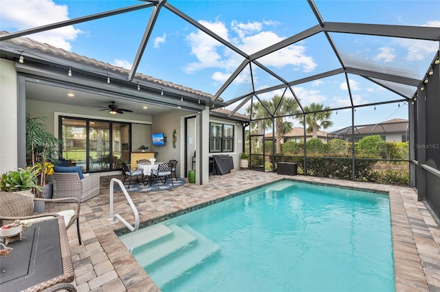 pool with a lanai, outdoor dining space, a ceiling fan, and a patio area