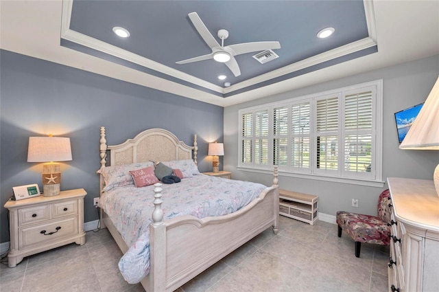 bedroom featuring ornamental molding, a tray ceiling, baseboards, and visible vents