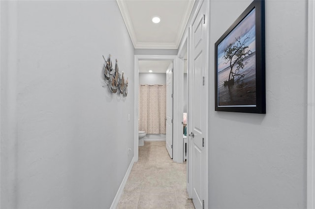 hall with baseboards and crown molding