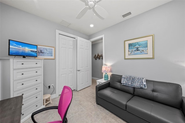 office space featuring baseboards, ceiling fan, and visible vents