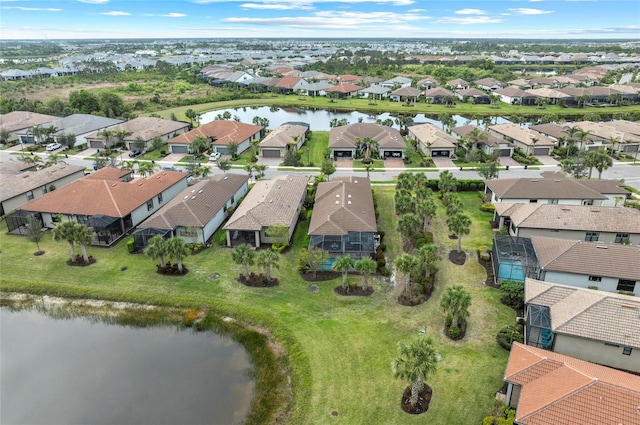 drone / aerial view with a residential view and a water view