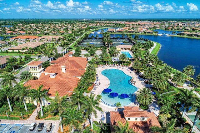 drone / aerial view featuring a water view and a residential view