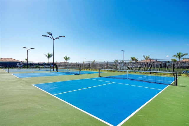 view of sport court featuring fence
