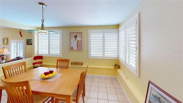 dining area with light tile patterned flooring and baseboards