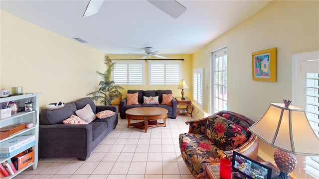 living room featuring a ceiling fan, light tile patterned floors, and visible vents