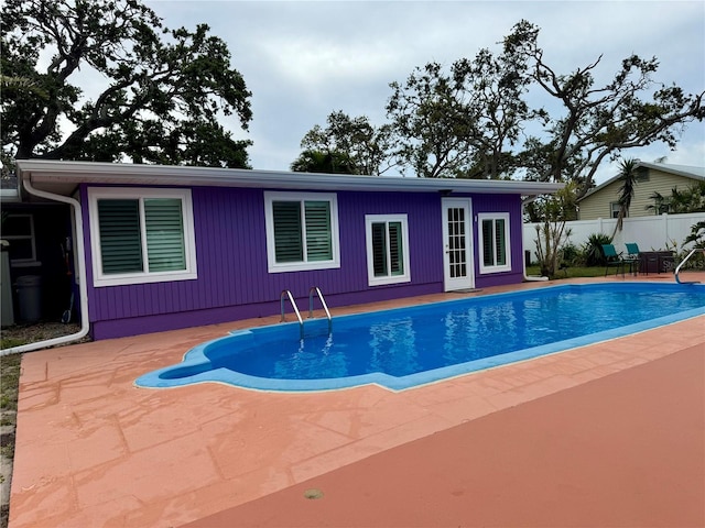 view of swimming pool featuring a fenced in pool, fence, and a patio