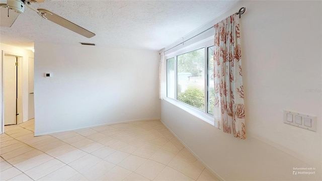unfurnished room with baseboards, a textured ceiling, and ceiling fan