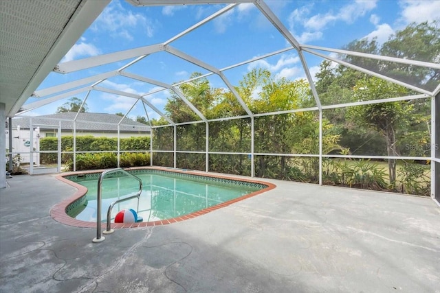 pool with a patio area and glass enclosure