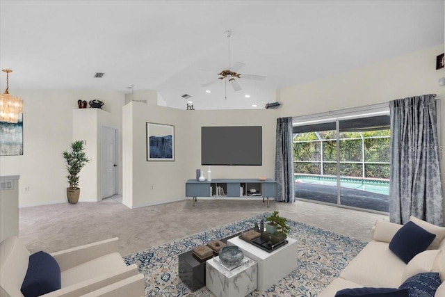cinema with ceiling fan with notable chandelier, vaulted ceiling, visible vents, and carpet floors