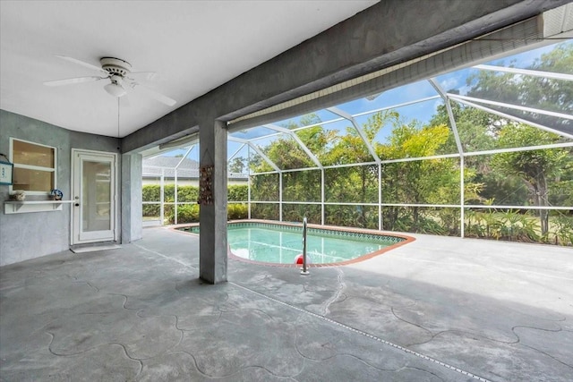 pool with a lanai, a patio area, and ceiling fan