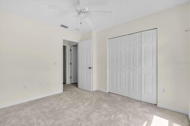 unfurnished bedroom with a closet, baseboards, a ceiling fan, carpet floors, and visible vents