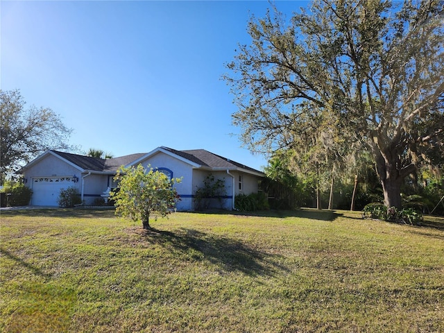 view of front facade with a front lawn, a garage, and stucco siding