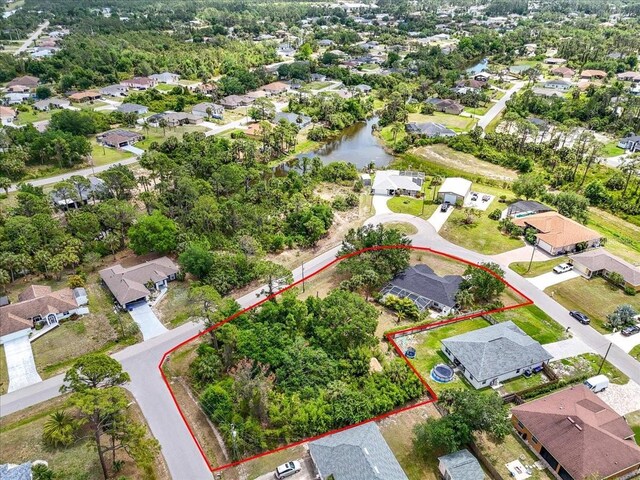 bird's eye view with a water view and a residential view