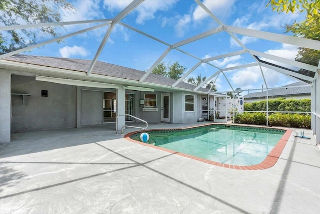 outdoor pool featuring a patio area and a lanai