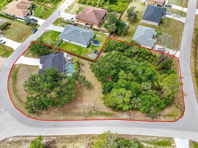 birds eye view of property with a residential view