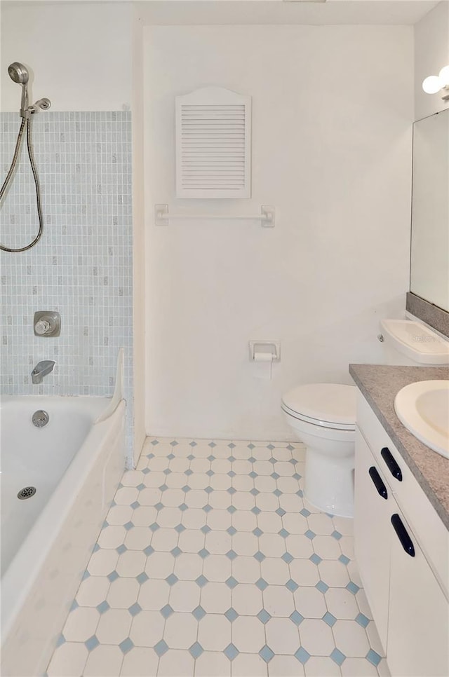 full bath featuring toilet, vanity, and  shower combination