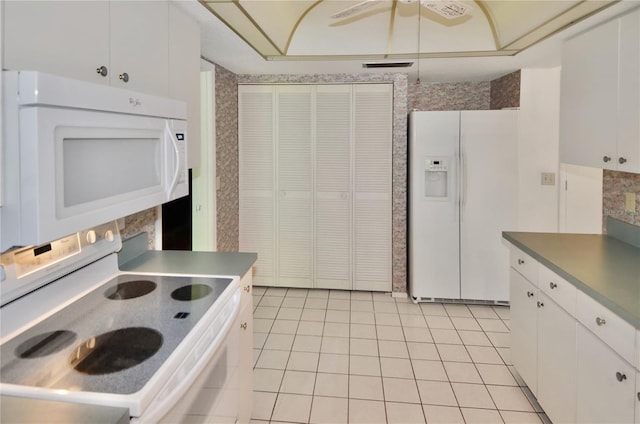 kitchen featuring white cabinetry, light tile patterned floors, ceiling fan, and white appliances