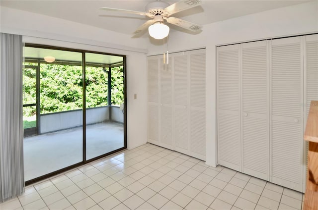 interior space with light tile patterned floors and a ceiling fan