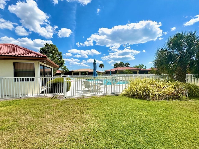 view of yard with fence and a community pool